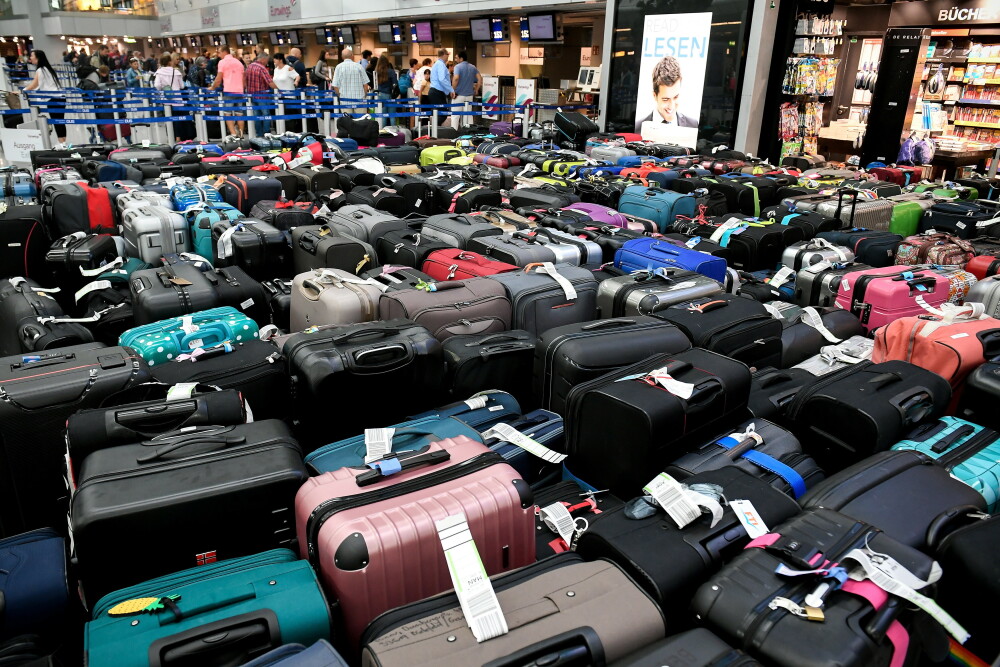 Imagini cu 2.500 de bagaje blocate în aeroport. Pasagerii, nevoiți să plece fără ele - Imaginea 1