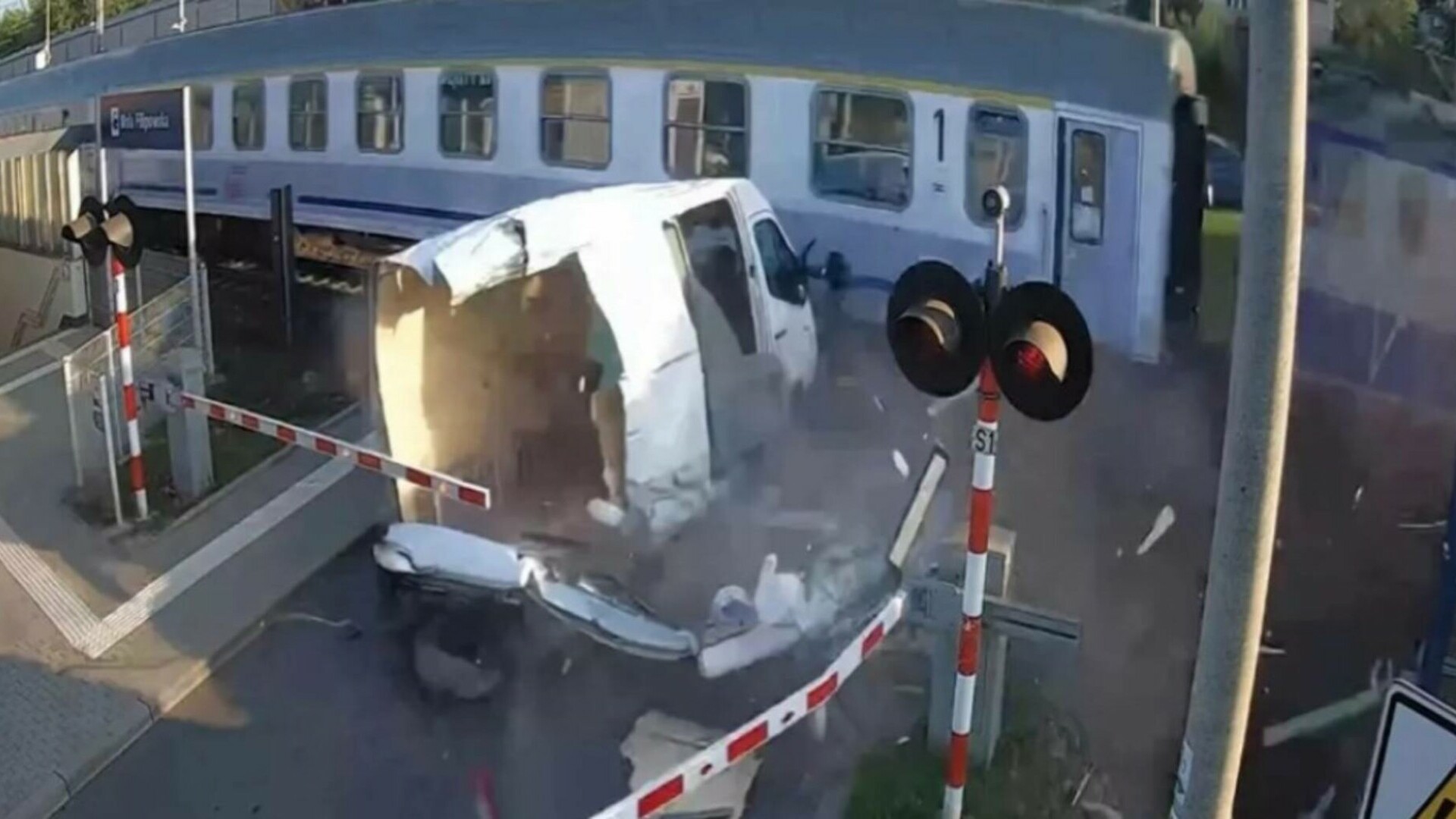 Momentul în care o dubiță blocată între bariere este spulberată de un tren, în Polonia. Șoferul a scăpat ca prin minune