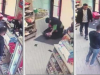 Momentul în care o vânzătoare se luptă cu hoții, în magazin, în timp ce 2 bărbați se uită