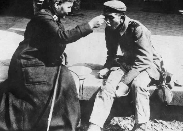 O asistenta de la Crucea Rosie din Franta hraneste un soldat ranit: Imagini emotionante din timpul Primului Razboi Mondial