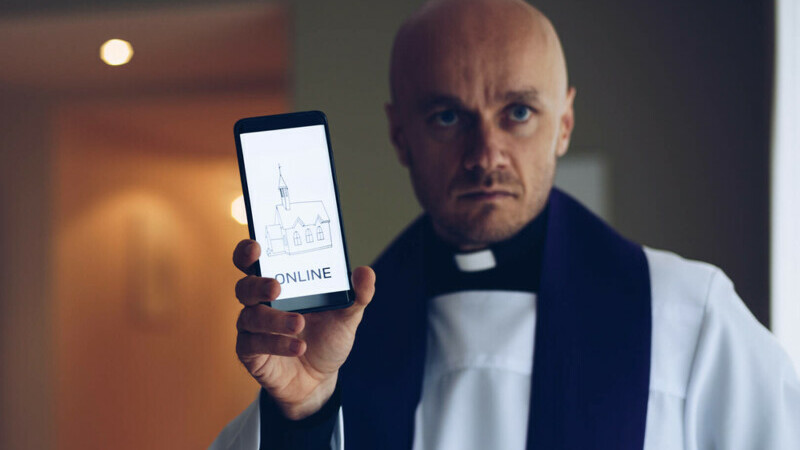 Preotul care sfințește telefoanele credincioșilor, ca să-i protejeze de „fake news” și ura din online