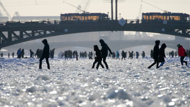 Localnicii se plimbă pe râul înghețat care trece prin centrul Sankt Petersburgului